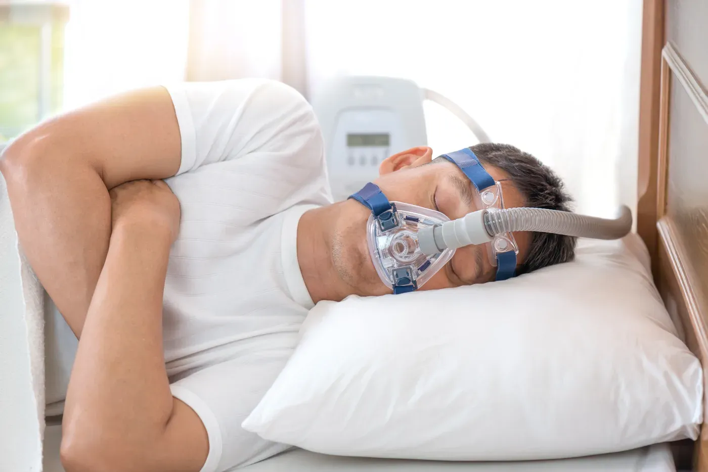 Man sleeping on his side wearing a CPAP mask