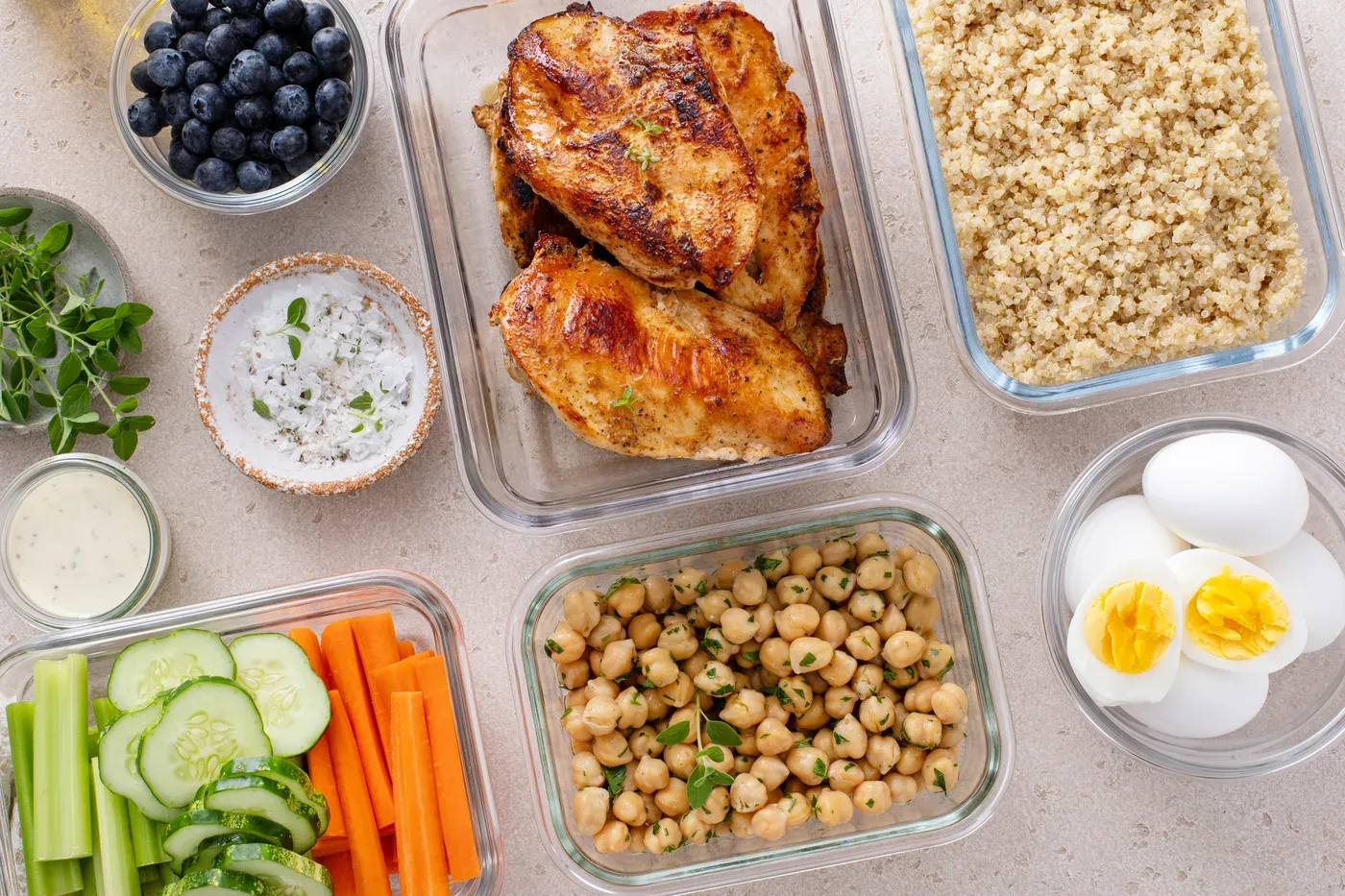 Meal-prep containers of chicken, rice, eggs and vegetables
